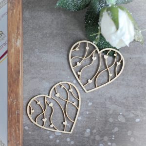 two small decorative laser cut chipboard hearts with tiny hearts inside