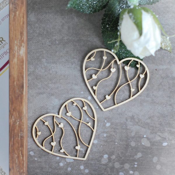 two small decorative laser cut chipboard hearts with tiny hearts inside