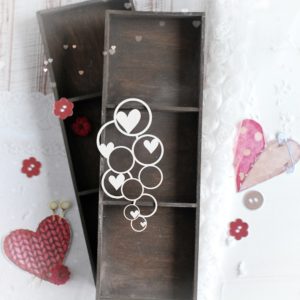small decorative laser cut chipboard bubbles with hearts background